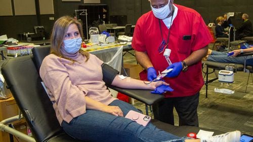 Ricky Green (right) draws blood samples from reporter Keri Janton as she donates blood at a Red Cross drive at Gwinnett Church in Sugar Hill on Monday April 12th, 2021.
PHIL SKINNER FOR THE ATLANTA JOURNAL-CONSTITUTION.