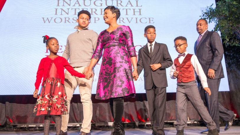 Atlanta mayor elect Keisha Lance-Bottoms and her family take the stage for prayer during the Atlanta inaugural interfaith worship service held at Impact Church in East Point, Tuesday. ALYSSA POINTER/ALYSSA.POINTER@AJC.COM