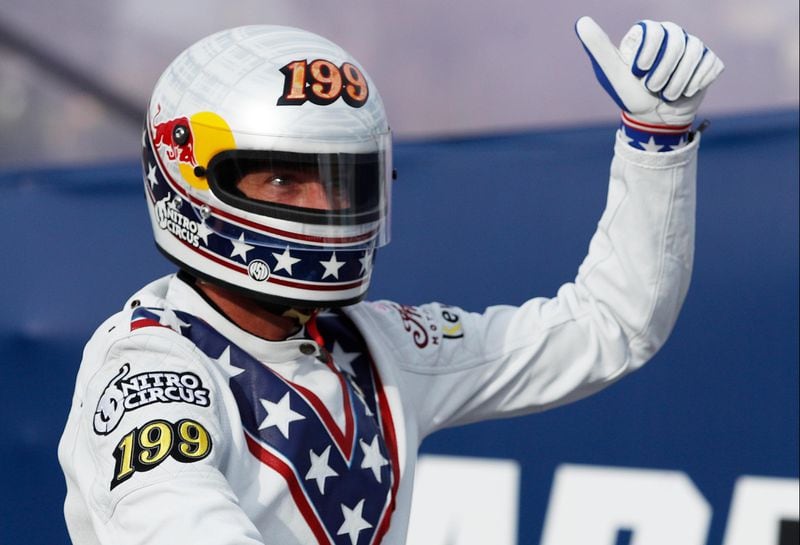 Travis Pastrana celebrates after jumping a row of crushed cars on a motorcycle Sunday, July 8, 2018, in Las Vegas.