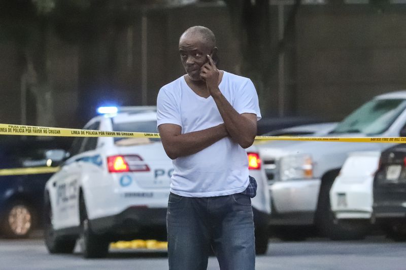 Tirrell Acevedo talks on the phone at the scene where his son, Kapri Ward, 29, was shot to death July 1 at the Durant Sugarloaf Apartments on Marlowe Drive. 