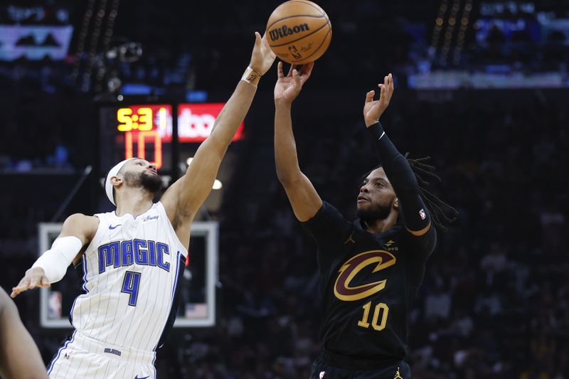 Cleveland Cavaliers guard Darius Garland (10) shoots against Orlando Magic guard Jalen Suggs (4) during the first half of Game 5 of an NBA basketball first-round playoff series, Tuesday, April 30, 2024, in Cleveland. (AP Photo/Ron Schwane)
