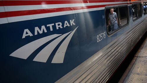A passenger passes by an Amtrak train at Union Station in Washington, DC. Several Amtrak routes along the east coast of the U.S. have been suspended or changed because of the expected effects of Tropical Storm Hermine. (Photo by Alex Wong/Getty Images)