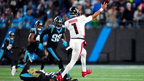 Falcons quarterback Marcus Mariota passes under pressure during the first half against the Panthers on Thursday night in Charlotte, N.C. (AP Photo/Jacob Kupferman)