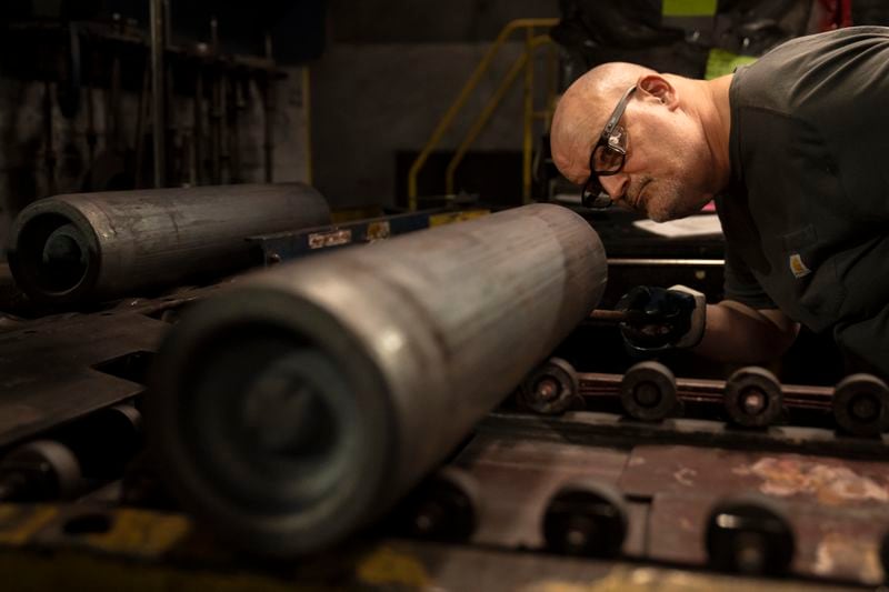 FILE -A steel worker inspects a 155 mm M795 artillery projectile during the manufacturing process at the Scranton Army Ammunition Plant in Scranton, Pa., Thursday, April 13, 2023. The Pentagon could get weapons moving to Ukraine within days if Congress passes a long-delayed aid bill. That's because it has a network of storage sites in the U.S. and Europe that already hold the ammunition and air defense components that Kyiv desperately needs. Moving fast is critical, CIA Director Bill Burns said Thursday, April 18, 2024. (AP Photo/Matt Rourke, File)