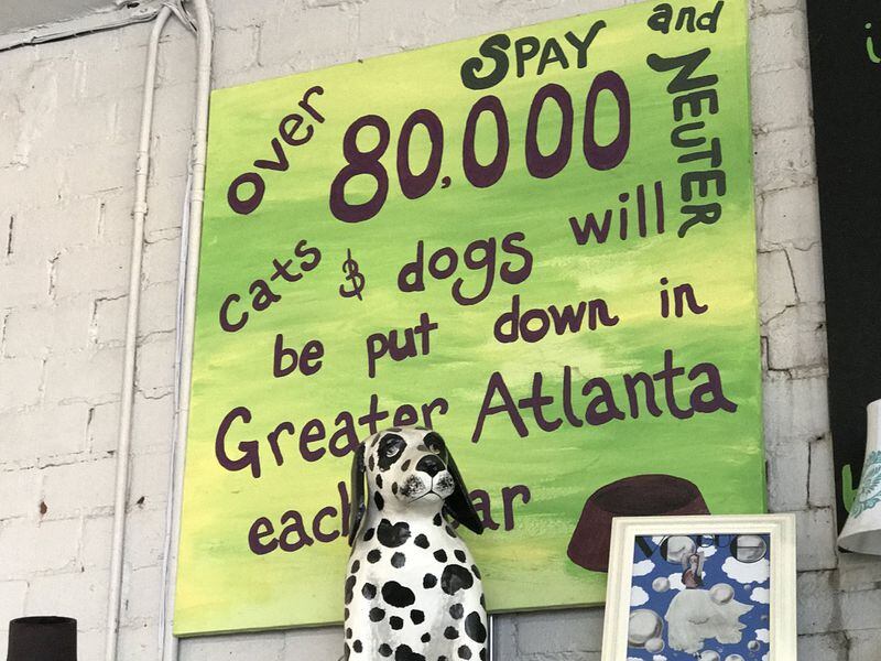 The Second Life Atlanta thrift store is decorated with pet art, some of which carries a message. CREDIT: SHELIA POOLE