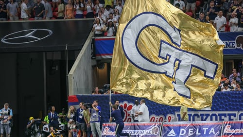 A flag is waved after Georgia Tech scores a touchdown in the second half of the Chick-fil-A Kickoff Game against Clemson at Mercedes-Benz Stadium on Monday, September 5, 2022.  (Arvin Temkar / arvin.temkar@ajc.com)