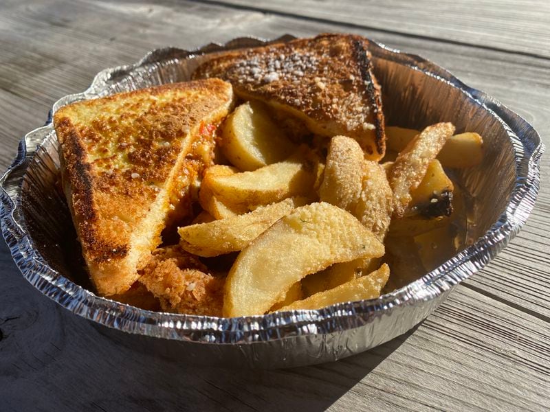 Thanks to pimento cheese and red pepper jelly, the Southern monte cristo at the Brunch Apothecary delightfully straddles the sweet-savory line. The sandwich comes with roasted potato wedges. Ligaya Figueras/ligaya.figueras@ajc.com
