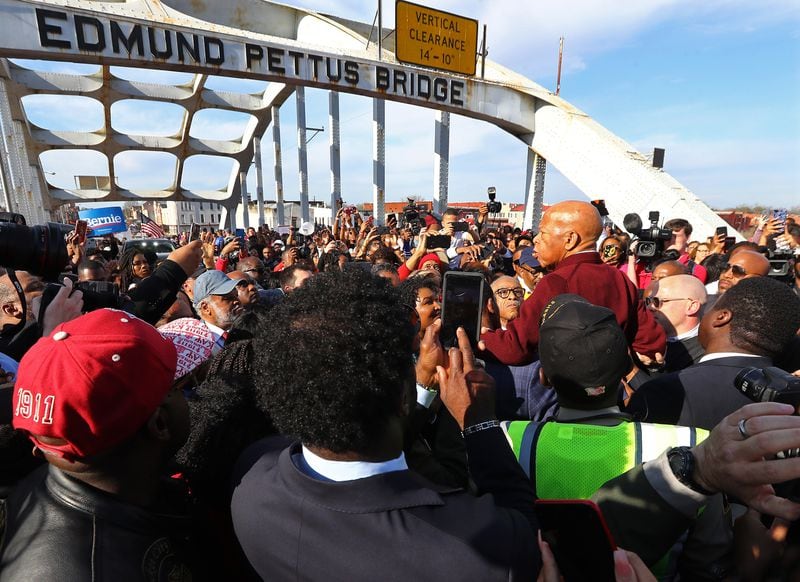A group of men hoist U.S. Rep. John Lewis, D-Atlanta, on their shoulders so he can speak to the crowd of marchers at the Edmund Pettus Bridge during the reenactment of Bloody Sunday on Sunday, March 1, 2020, in Selma, Alabama. (Photo: Curtis Compton / ccompton@ajc.com)
