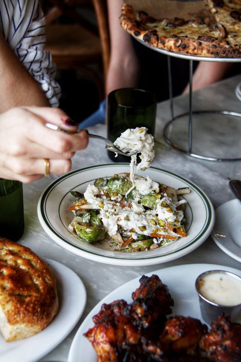 Genuine Pizza’s warm Brussels sprouts with burrata, sliced pears, and pistachios is a lovely salad or side dish for sharing. CONTRIBUTED BY GENUINE PIZZA