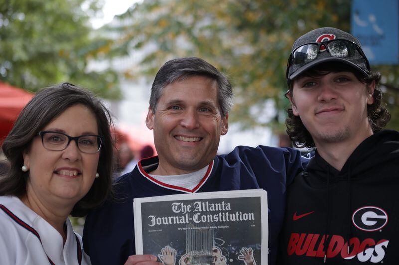 Lisa Keiffer, left, her husband, Todd, center, and their 22-year-old son, Jacob, attended the Braves' World Series celebration parade in Atlanta on Nov. 5, 2021. (Photo by Anfernee Patterson/AJC)