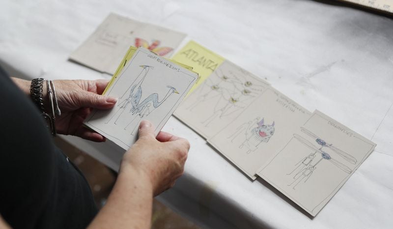 Organizing a parade is like creating a storyboard for a movie. Here Chantelle Rytter examines the features for each moment of the BeltLine lantern Parade, that she has written and drawn on notecards. BOB ANDRES  /BANDRES@AJC.COM