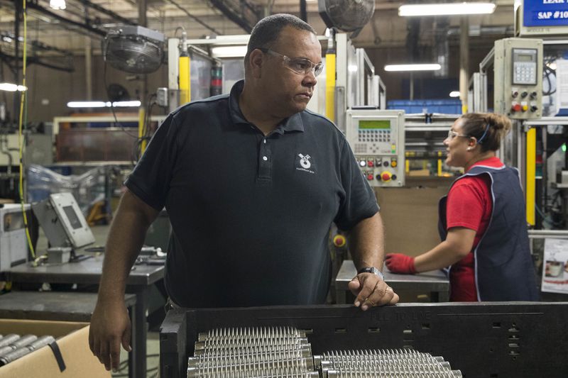 08/02/2018 -- Cumming, Georgia -- Vincente Delphin, Jr., director of the automotive business unit at American BOA Inc., watches over production at the manufacturing plant in Cumming, Thursday, August 2, 2018.  (ALYSSA POINTER/ALYSSA.POINTER@AJC.COM)