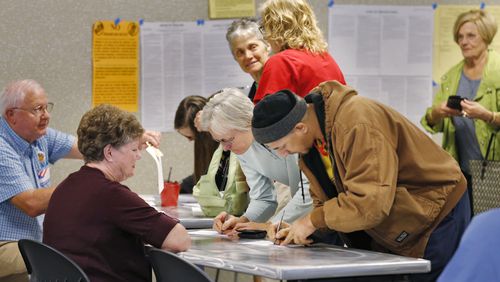 Voters cast ballots at the Tucker Library on Nov. 3 to overhaul the DeKalb Board of Ethics. BOB ANDRES / BANDRES@AJC.COM