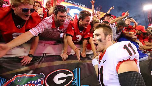 Georgia quarterback Jake Fromm celebrates with fans after Georgia beat Florida 42-7 in an NCAA college football game, Saturday, Oct. 28, 2017, in Jacksonville, Fla. (Curtis Compton/Atlanta Journal-Constitution via AP)