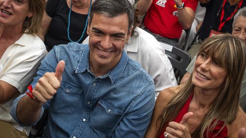 FILE - Spain's Prime Minister Pedro Sanchez next to his wife Begona Gomez, gives a thumb up during a campaign closing meeting in Madrid, Spain, Friday, July 21, 2023. Spain is in nail-biting suspense Monday as it waits for Prime Minister Pedro Sanchez to announce whether he will continue in office or not. Sanchez, 52, shocked the country on Thursday, announcing he was taking five days off to think about his future after a court opened preliminary proceedings against his wife on corruption allegations. (AP Photo/Emilio Morenatti, File)
