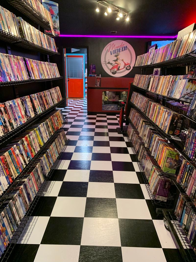 The fake Mondo Video Anthony Sant'Anselmo created in his Woodstock home features black-and-white checkered floors, evoking 1950s diners. RODNEY HO/rho@ajc.com