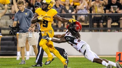 Kennesaw State running back Shaq Terry stiff arms a Clark Atlanta University football player during a game on Sept. 22, 2018 at Fifth Third Bank Stadium.