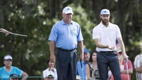 Mark O'Meara, front left, talks with his son Shaun O'Meara, during the first round of the Father/Son Challenge golf tournament in Orlando in 2015. (AP photo)