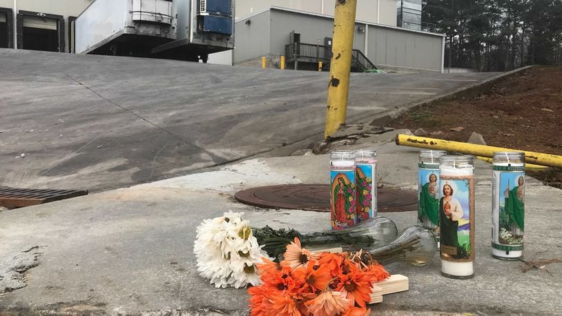 Flowers and candles are seen outside the Foundation Food Group poultry processing plant in Gainesville, Georgia, on Saturday, Jan. 30, 2021. (Photo: Vanessa McCray / Vanessa.McCray@ajc.com)