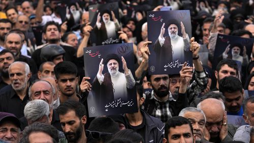People hold up posters of President Ebrahim Raisi during a mourning ceremony for him at Vali-e-Asr square in downtown Tehran, Iran, Monday, May 20, 2024. Iranian President Raisi and the country's foreign minister were found dead Monday hours after their helicopter crashed in fog, leaving the Islamic Republic without two key leaders as extraordinary tensions grip the wider Middle East. (AP Photo/Vahid Salemi)