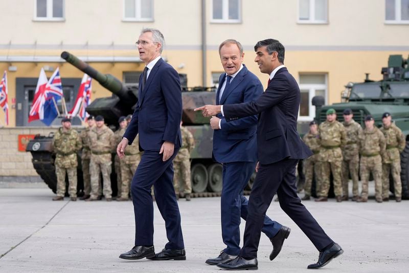 Britain's Prime Minister Rishi Sunak, right, Poland's Prime Minister Donald Tusk and NATO Secretary General Jens Stoltenberg, left, arrive together at the Armourd Brigade barracks in Warsaw, Poland, Tuesday, April 23, 2024.(AP Photo/Alastair Grant, Pool)
