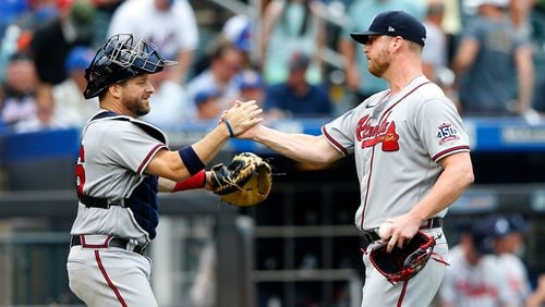 Atlanta Braves catcher Stephen Vogt shakes hands with relief pitcher Will Smith after defeating the New York Mets 6-3, Thursday, July 29, 2021, in New York. (AP Photo/Noah K. Murray)