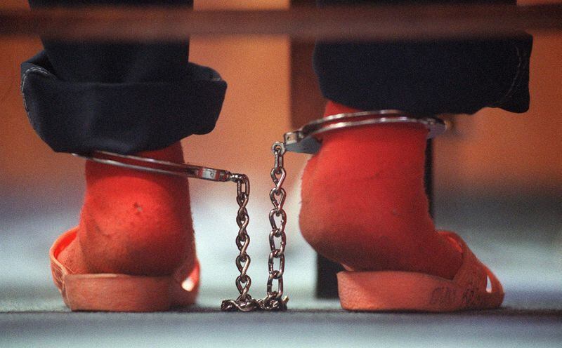 Shackles bind the legs of a 10-year-old girl who was being held on a number of charges, including running away and prostitution, during a November 2000 hearing in Fulton County Juvenile Court before Judge Nina R. Hickson. AJC FILE PHOTO