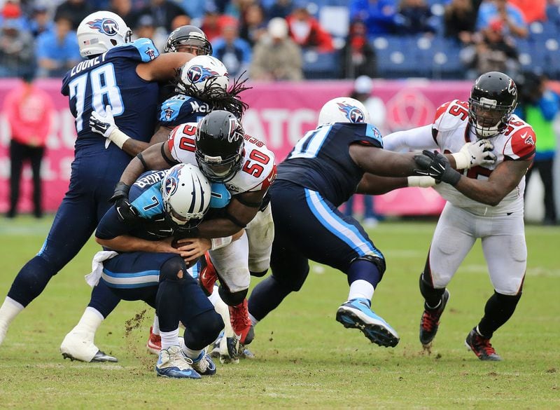 102515 NASHVILLE: —SACKED — Falcons linebacker O’Brien Schofield sacks Titans quarterback Zach Mettenberger while Jonathan Babineaux applys pressure during the third quarter in a football game on Sunday, Oct. 25, 2015, in Nashville. The Falcons beat the Titans 10-7. Curtis Compton / ccompton@ajc.com