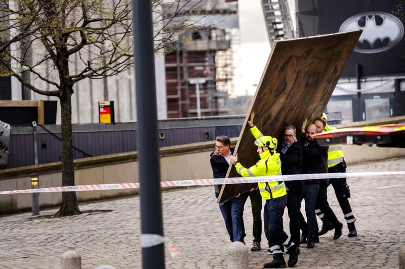 CEO of Danish Business, Brian Mikkelsen, and others carry paintings out of the burning building as the Stock Exchange burns in Copenhagen, Denmark, Tuesday, April 16, 2024. A fire raged through one of Copenhagen’s oldest buildings on Tuesday, causing the collapse of the iconic spire of the 17th-century Old Stock Exchange as passersby rushed to help emergency services save priceless paintings and other valuables. (Ida Marie Odgaard/Ritzau Scanpix via AP)