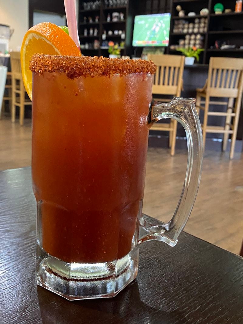 A massive michelada combines your choice of domestic or imported beer with ample tomato juice and hot sauces, in a glass rimmed with Tajin Mexican seasoning. Ligaya Figueras/ligaya.figueras@ajc.com
