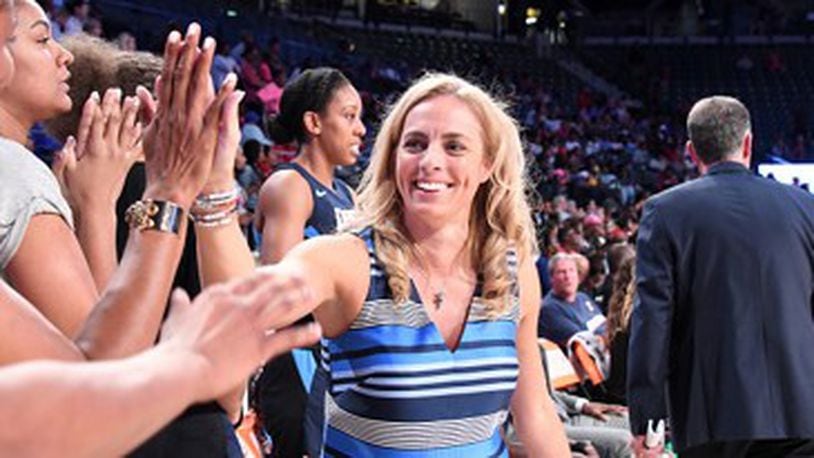 From a season ago, Dream coach Nicki Collen accepts the congratulations of her fans.  (Photo: Scott Cunningham/Getty Images)