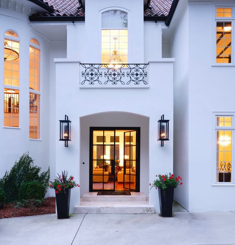 "We took a heavy, dark and foreboding entrance and make it light, bright and inviting.  Changing the front doors to the steel and glass, changing the flooring to a lighter stone and painting the outside home a more neutral color lightened the mood of the entrance."