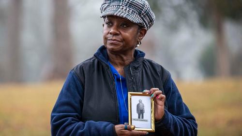 Peggy Fitzpatrick Tatum, 65, stands for a portrait holding an image of her great-grandfather, Willie Fitzpatrick, at East Lake Park in Atlanta’s East Lake community. Fitzpatrick was a victim of the Tuskegee Experiment, which was an unethical medical study that targeted Black men for more than 40 years. Despite this experiment being a part of her family legacy, Tatum is still seeking to participate in the COVID-19 vaccination.  (Alyssa Pointer / Alyssa.Pointer@ajc.com)