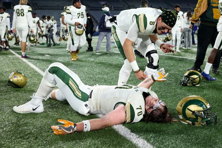 Dec. 30, 2020 - Atlanta, Ga: Grayson quarterback Jake Garcia, top right, celebrates with offensive lineman Griffin Scroggs after their 38-14 win against Collins Hill during the Class 7A state high school football final at Center Parc Stadium Wednesday, December 30, 2020 in Atlanta. JASON GETZ FOR THE ATLANTA JOURNAL-CONSTITUTION