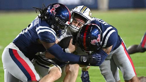 Mississippi linebacker Jeremiah Jean-Baptiste, left, and safety Daijahn Anthony tackle Georgia Tech quarterback Haynes King during the second half an NCAA college football game in Oxford, Miss., Saturday, Sept. 16, 2023. Georgia Tech lost 48-23.  (AP Photo/Thomas Graning)