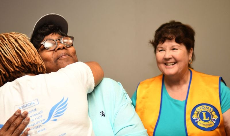 Dawn Wells (left) gives Sara Randall of Atlanta (center) a hug as Nancy Morton-Linek of Conyers, a Lions Club volunteer, watches at Dawn Wells Fitness in Covington recently. Angel Eyes Fitness and Nutrition, a local nonprofit, provides exercise instruction to the blind and visually impaired. CONTRIBUTED BY REBECCA BREYER