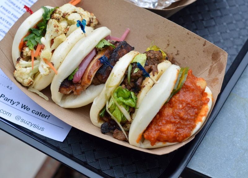 From Suzy Siu’s Baos, left to right: roasted cauliflower, pork belly, Korean BBQ beef and Korean fried chicken. (photo: Henri Hollis for the AJC)