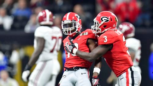 January 8, 2018 Atlanta - Georgia defensive back Deandre Baker (18) and Georgia linebacker Roquan Smith (3) celebrate in the second half during College Football Playoff National Championship at Mercedes-Benz Stadium on Monday, January 8, 2018. Alabama came back from a 13-point second half deficit after switching to the young quarterback in a dramatic 26-23 overtime victory over Georgia in the college football title game Monday night at Mercedes-Benz Stadium. HYOSUB SHIN / HSHIN@AJC.COM