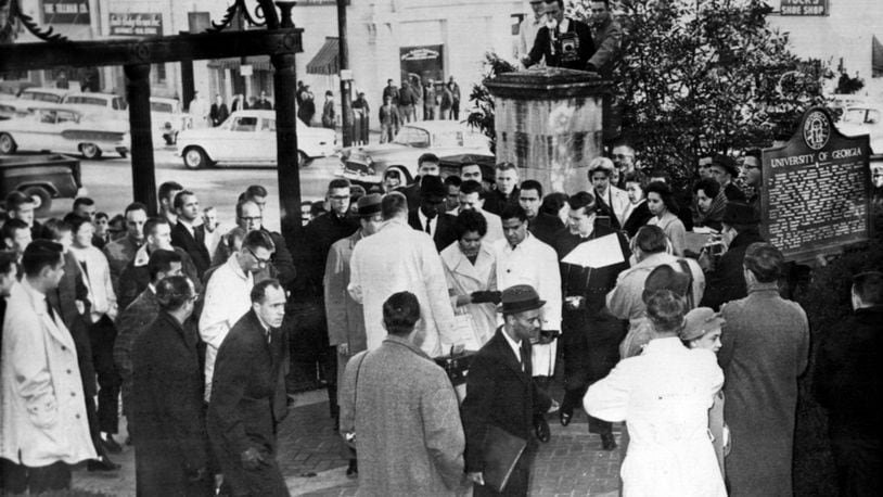 Rioting white students at UGA forced the first Black undergraduate students admitted, Charlayne Hunter and Hamilton Holmes, shown here arriving on the campus in 1961, to be removed from their dorms and taken out of Athens. When 340 UGA faculty members signed a petition calling for their return, a Board of Regents member demanded to see the list in order to punish them. (AJC file photo)