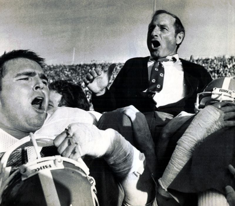 Georgia football coach Vince Dooley gets the victor's ride Saturday, November 15, 1982 at Auburn after his Bulldogs won the Southeastern Conference championship. At left is Kevin Jackson (Joe Benton/AP)