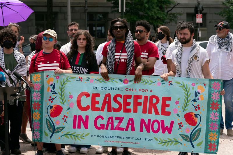 People holding a banner attend a news conference after police cleared a pro-Palestinian tent encampment at George Washington University early Wednesday and arrested demonstrators, Wednesday, May 8, 2024, in Washington. (AP Photo/Jose Luis Magana)