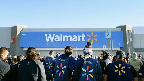 Walmart employees gather outside the Walmart store for a reopening event, Thursday in El Paso, Texas.