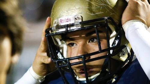 Dacula's Dylan Parr (5) puts on his helmet during the first half of a 2019 game. (Casey Sykes/Special)