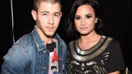 Nick Jonas and Demi Lovato pose for a photo backstage in Atlanta. (Photo by Kevin Mazur/Getty Images for Philly Mack)