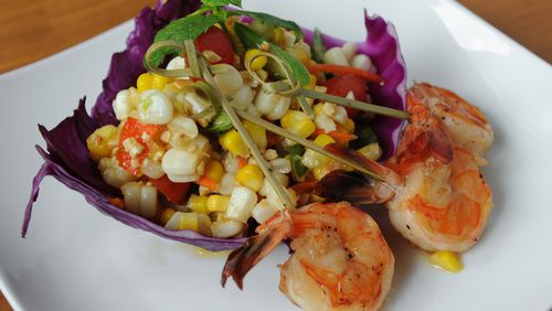 Corn Salad with white and yellow corn, cherry tomatoes, peanuts and green chili tossed in traditional Thai dressing and served with grilled shrimp. (BECKY STEIN PHOTOGRAPHY)