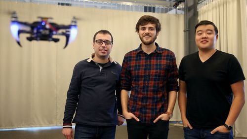 From left, researchers Giuseppe Loianno, Aaron Weinstein and Adam Cho stand for a portrait among a swarm of quadrotor drones using visual inertial odometry on Thursday, Jan. 25, 2018 at the Pennovation Center in Forgotten Bottom. Penn Engineering’s GRASP, or general robotics, automation, sensing & perception lab, has programmed the drones to fly into formations autonomously using a combination of a camera, accelerometer and gyrometer rather than GPS. (Tim Tai/Philadelphia Inquirer/TNS)