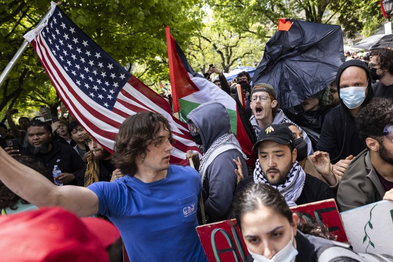 Pro-Palestinians protesters clash with counter-protesters at the encampment in the quad at the University of Chicago on the South Side, Friday, May 3, 2024. (Ashlee Rezin/Chicago Sun-Times via AP)