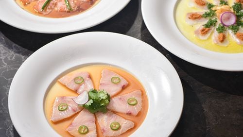 Nobu's yellowtail jalapeno sashimi is an artful arrangement of six thin slices of yellowtail each topped with a jalapeno ring and set in a yuzu-ponzu sauce, with a garnish of cilantro in the center. NOBU HOSPITALITY
