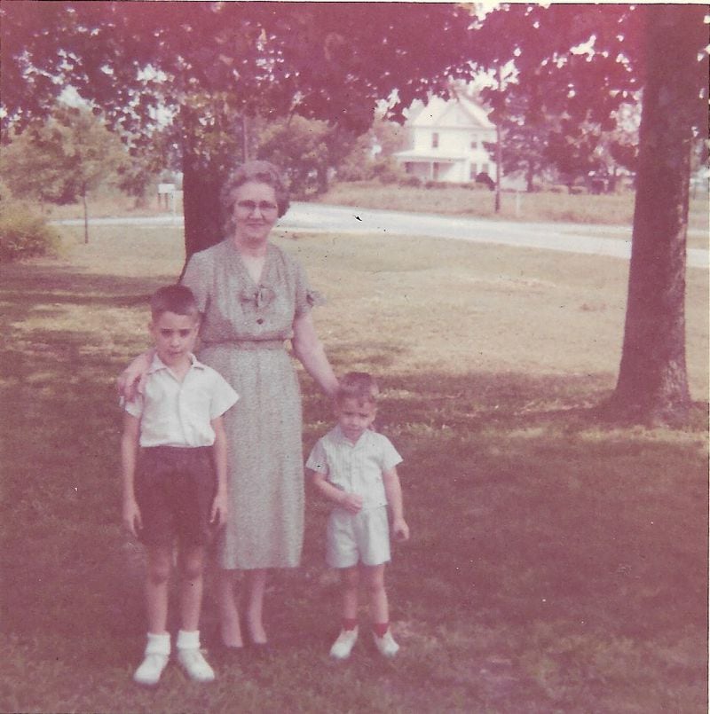 Bill and Jonathan King are seen in 1960 with their grandmother in her front yard in Colbert. Her fried chicken was a favorite at Sunday dinners. (Courtesy of the King family)