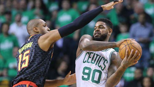 042216 BOSTON: Hawks center Al Horford defends against Celtics forward Amir Johnson in their NBA Eastern Conference first round playoff basketball game at TD Garden on Friday, April 22, 2016, in Boston. Curtis Compton / ccompton@ajc.comon